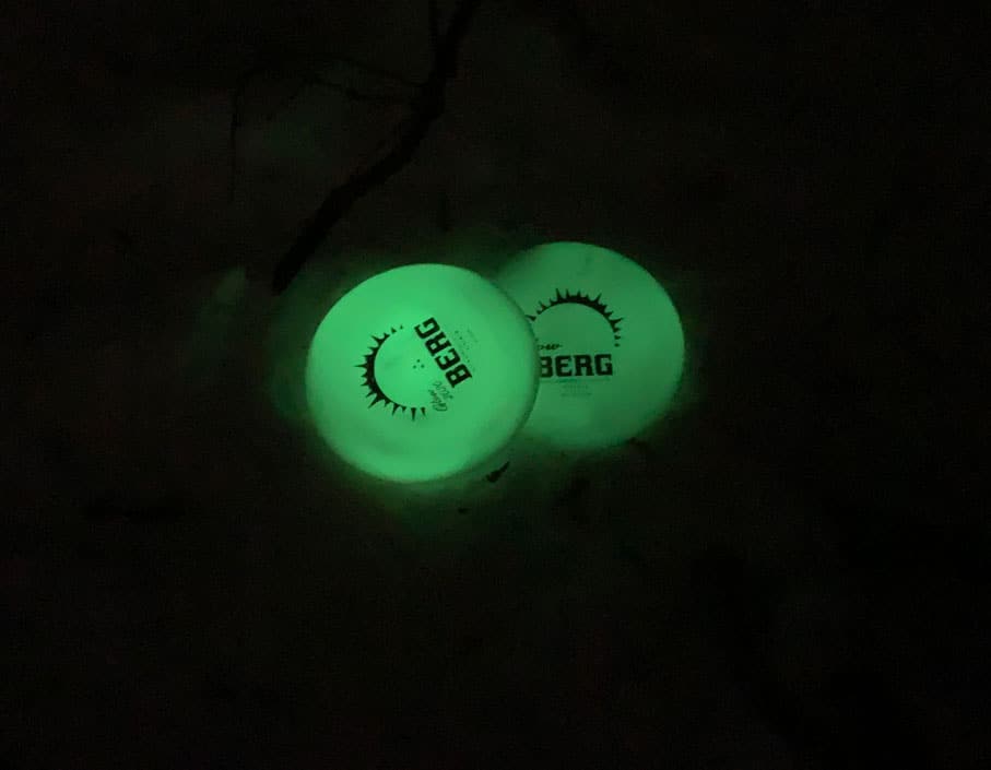 Glow discs sitting on the ground in a field