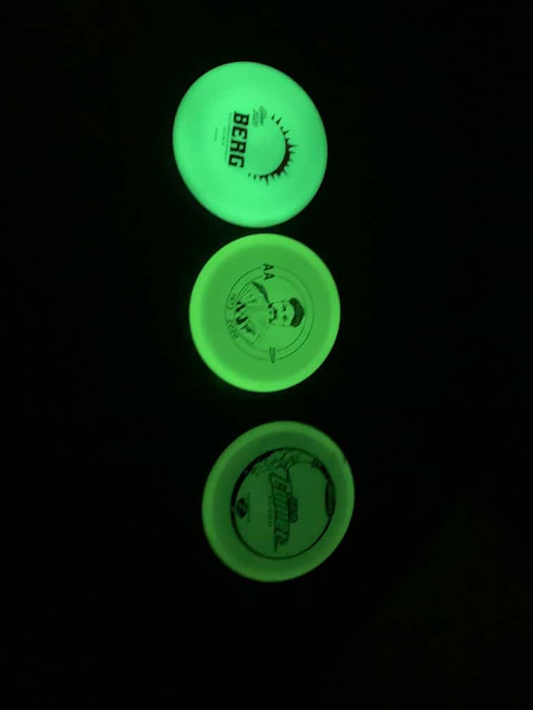 Three disc golf glow discs on the ground